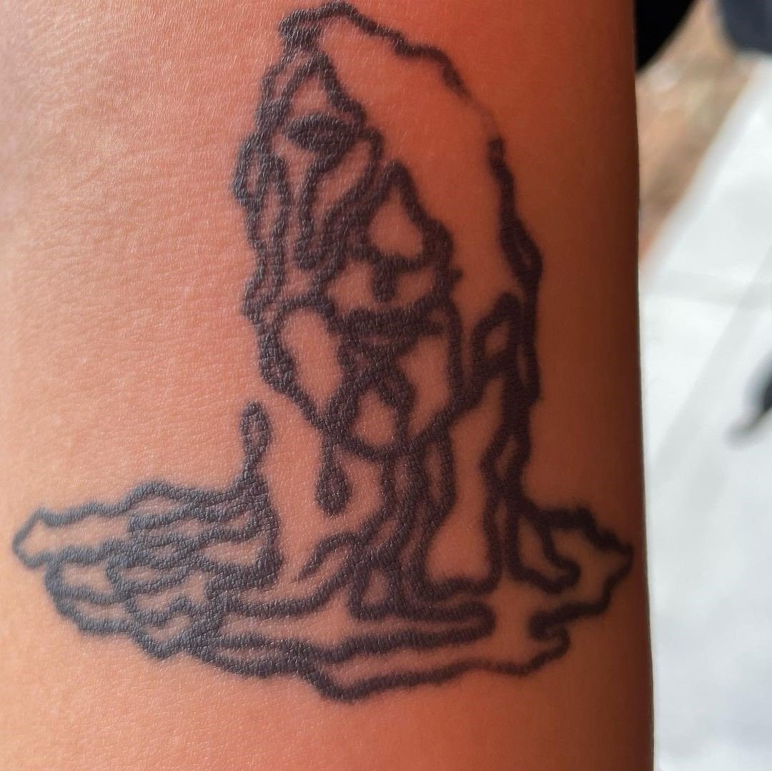 Tattoo artist making a mark